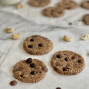 Healthy no bake cookies with dates and cashew nuts on parchment paper.