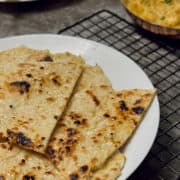 tandoori butter naan served in plate with butter paneer.