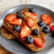 warm maple syrup drizzled over fresh sourdough french toast with fresh mixed berries.