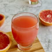 freshly squeezed grapefruit juice, served on board, with sliced grapefruits.