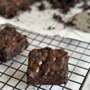 close up of tempting sweet potato chocolate brownie squares on wire rack.