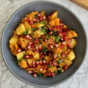 birds eye and close up view of sweet potato chaat with nectarine in a blue bowl.