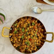 pindi chole in a serving dish, garnished with coriander.