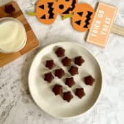 pumpkin spice chocolate candies with milk, pumpkin and Halloween decorations.