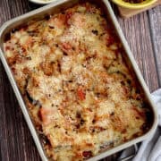 Cozy roasted eggplant and red pepper bake in a dish, topped with a golden, crispy layer of cheesy breadcrumbs.