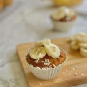 fluffy coconut flour banana cupcakes, topped with sliced banana and coconut flakes.