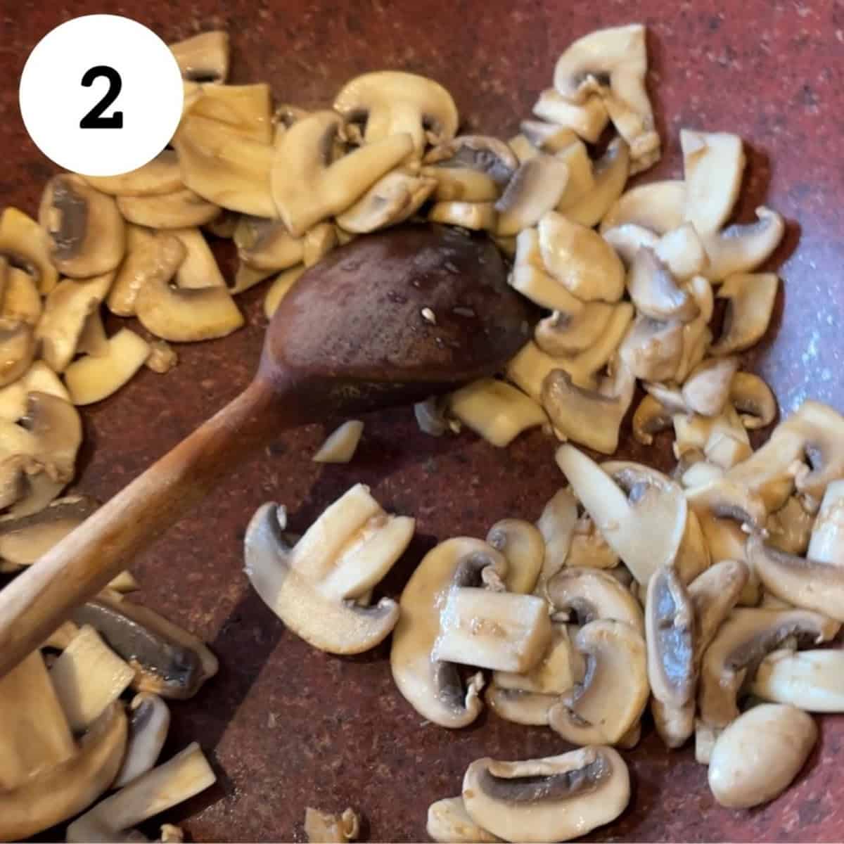 cooking mushrooms in pan.