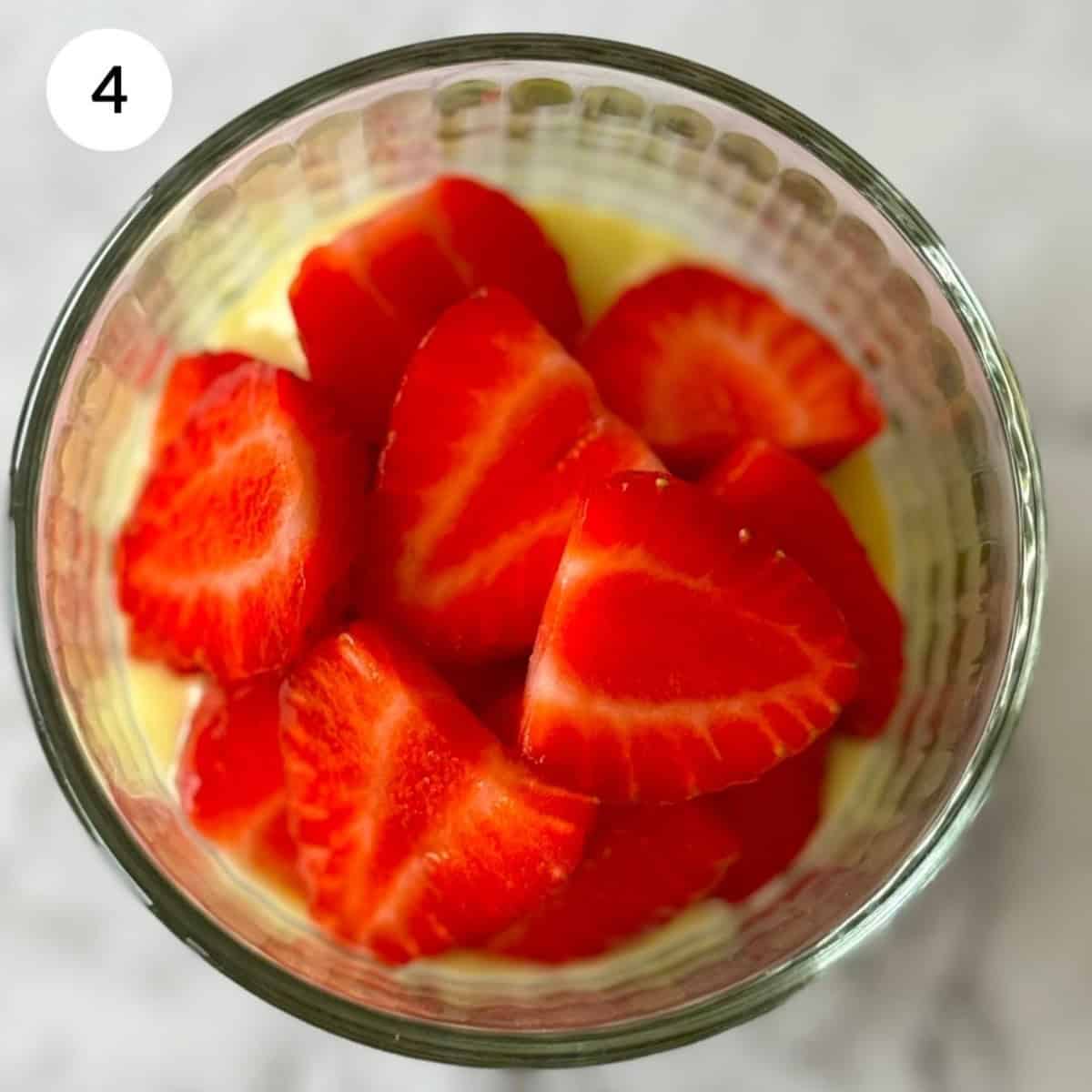 layering the matcha chia seed pudding with melted chocolate and sliced strawberries.