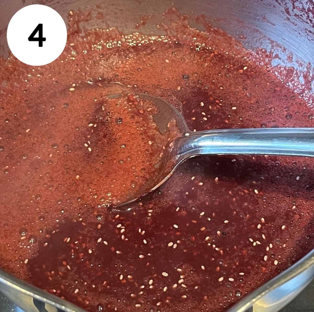 mixing cherry jam in pan.