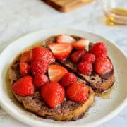chocolate French toast, with warm maple syrup, a sprinke of cacao powder and and fresh berries.