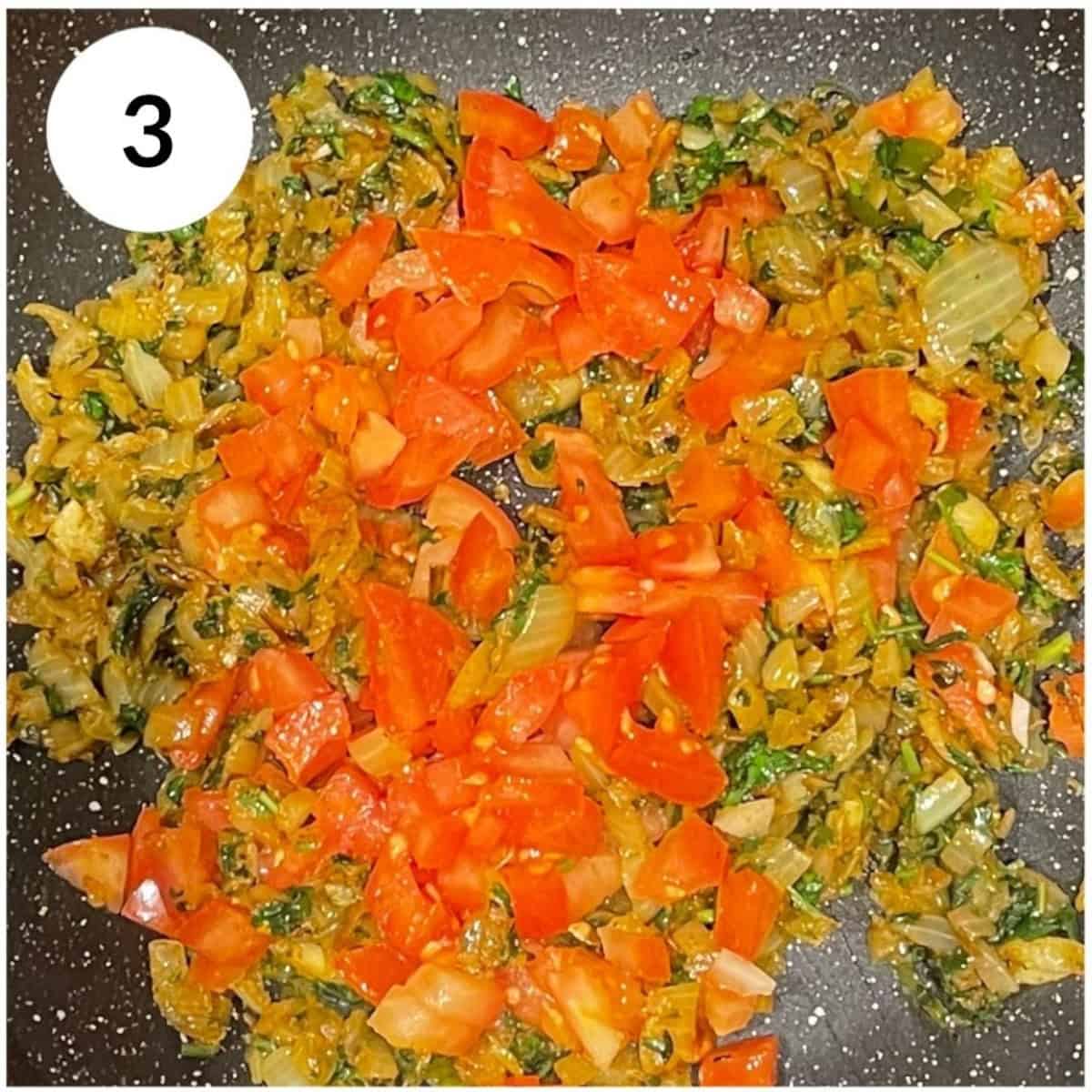 adding tomatoes to cook with onions.