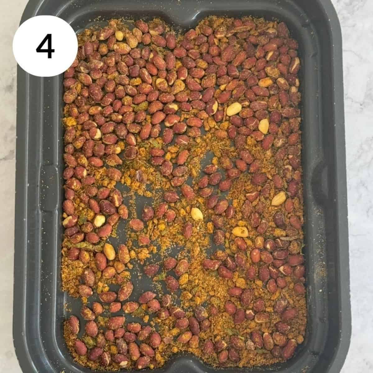 cooling cooked masala peanuts before serving them.