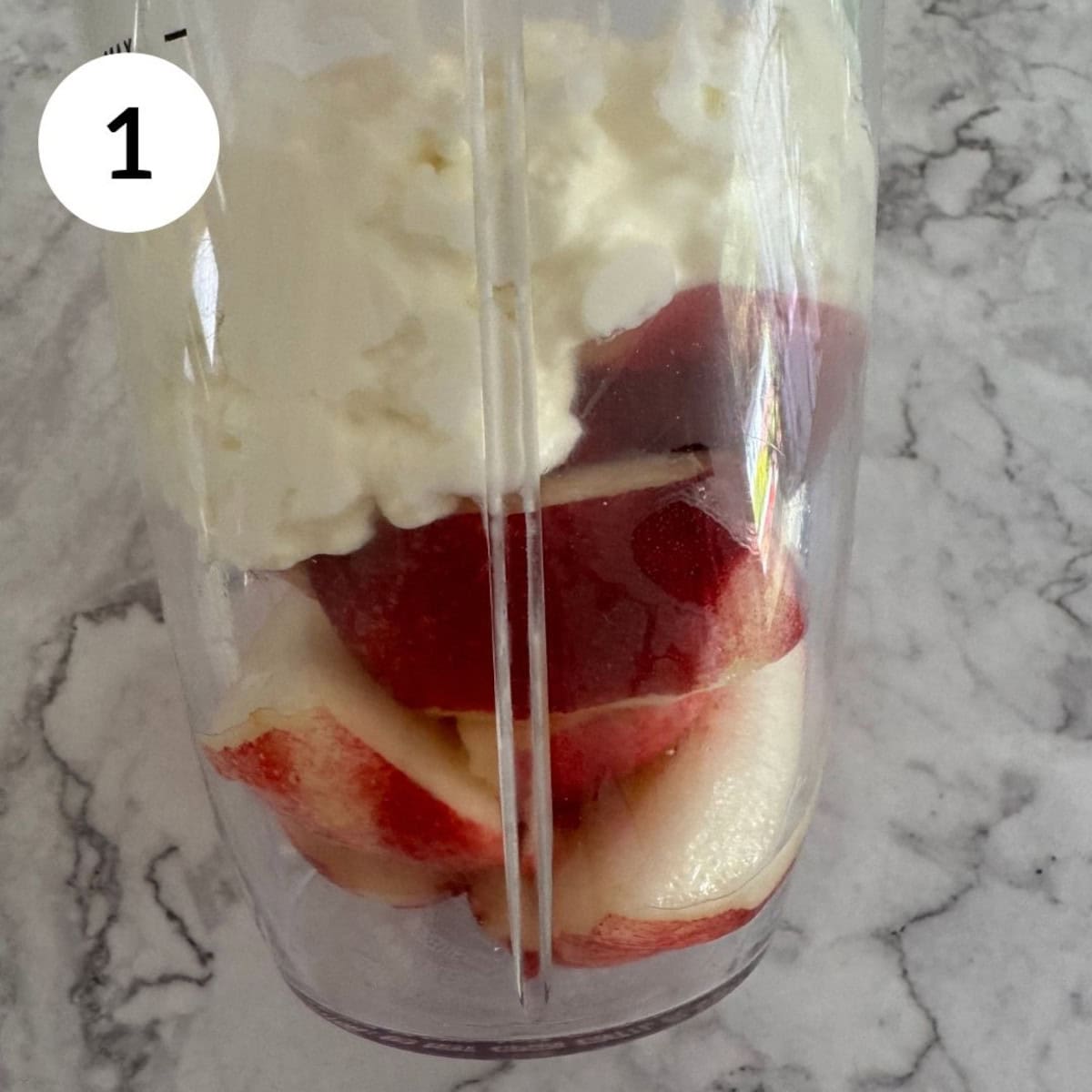 adding nectarine, cottage cheese and maple syrup to small blender.