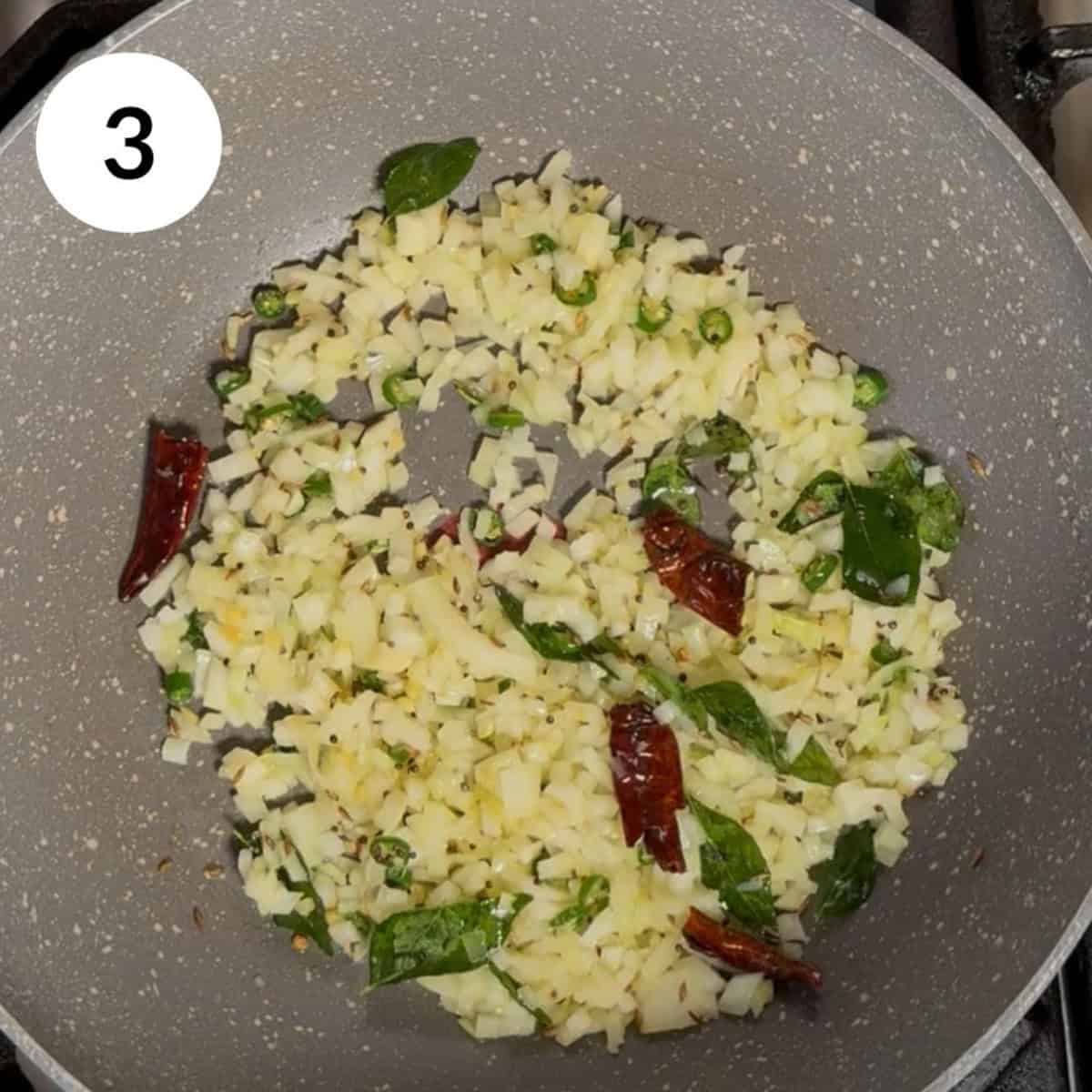 adding onions into pan and cooking.