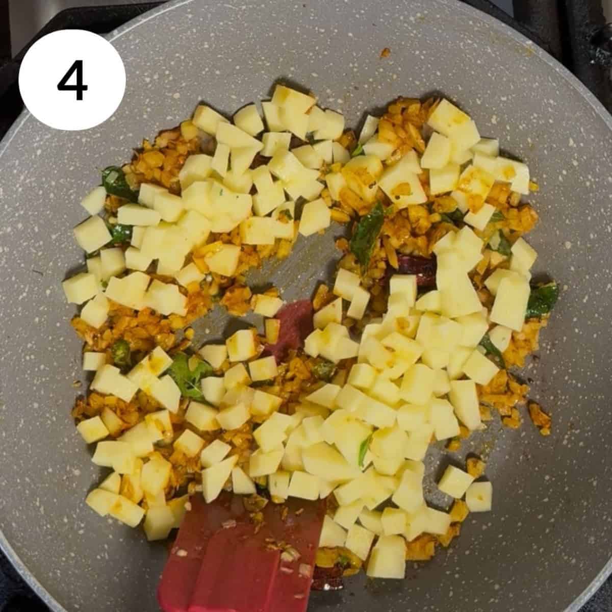 adding chopped potatoes into the pan.