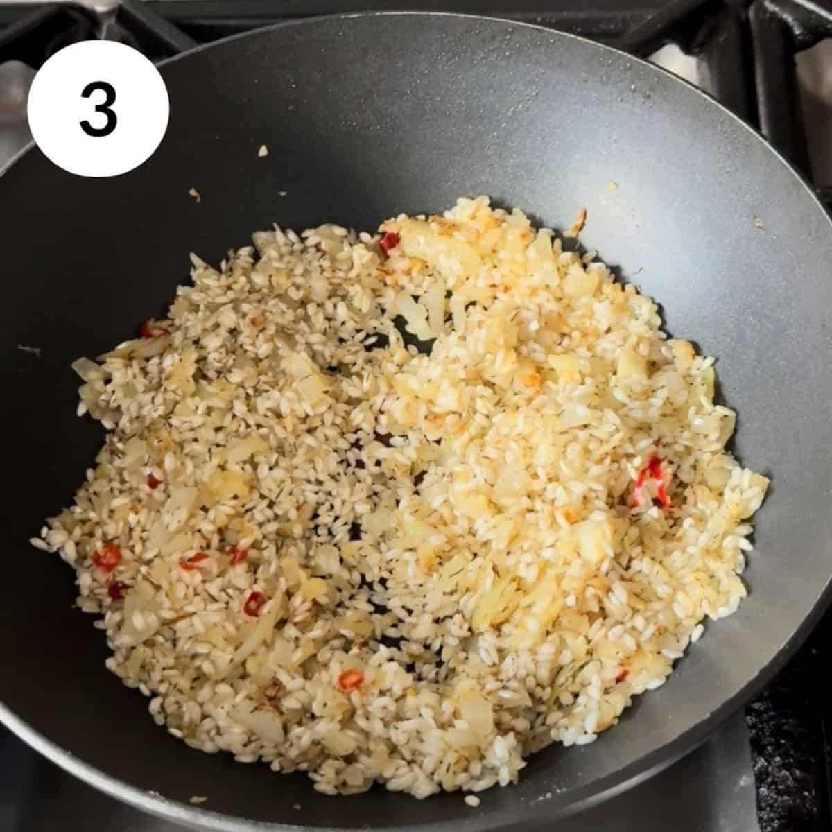 adding risotto rice and toasting in the pan.