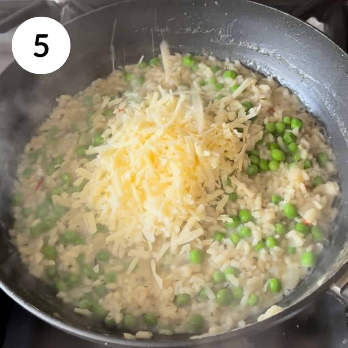 adding peas and cheese to the cooked risotto.
