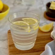 fresh lemon water, with sliced lemon wedges.