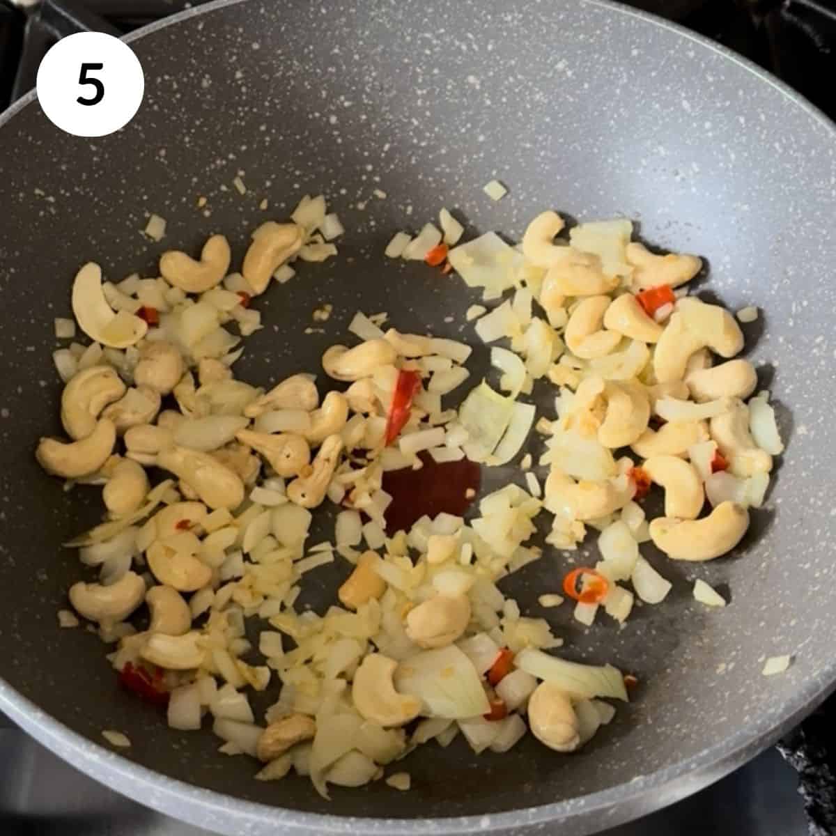 adding whole cashews into the pan.