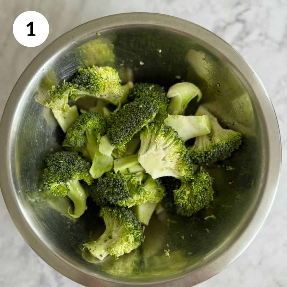 fresh broccoli florets in bowl, ready to be roasted.